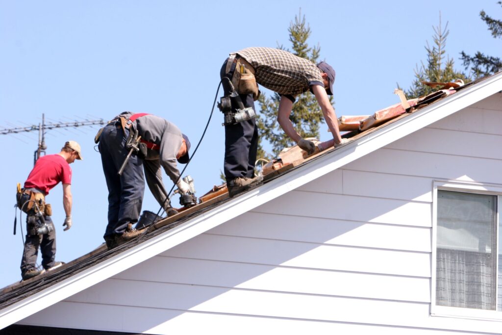 3 man repairing the roof